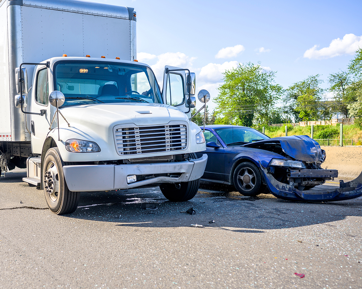 Commercial vehicle and passenger vehicle on the road after a crash - Spitzer Legal Commercial Vehicle Accident 