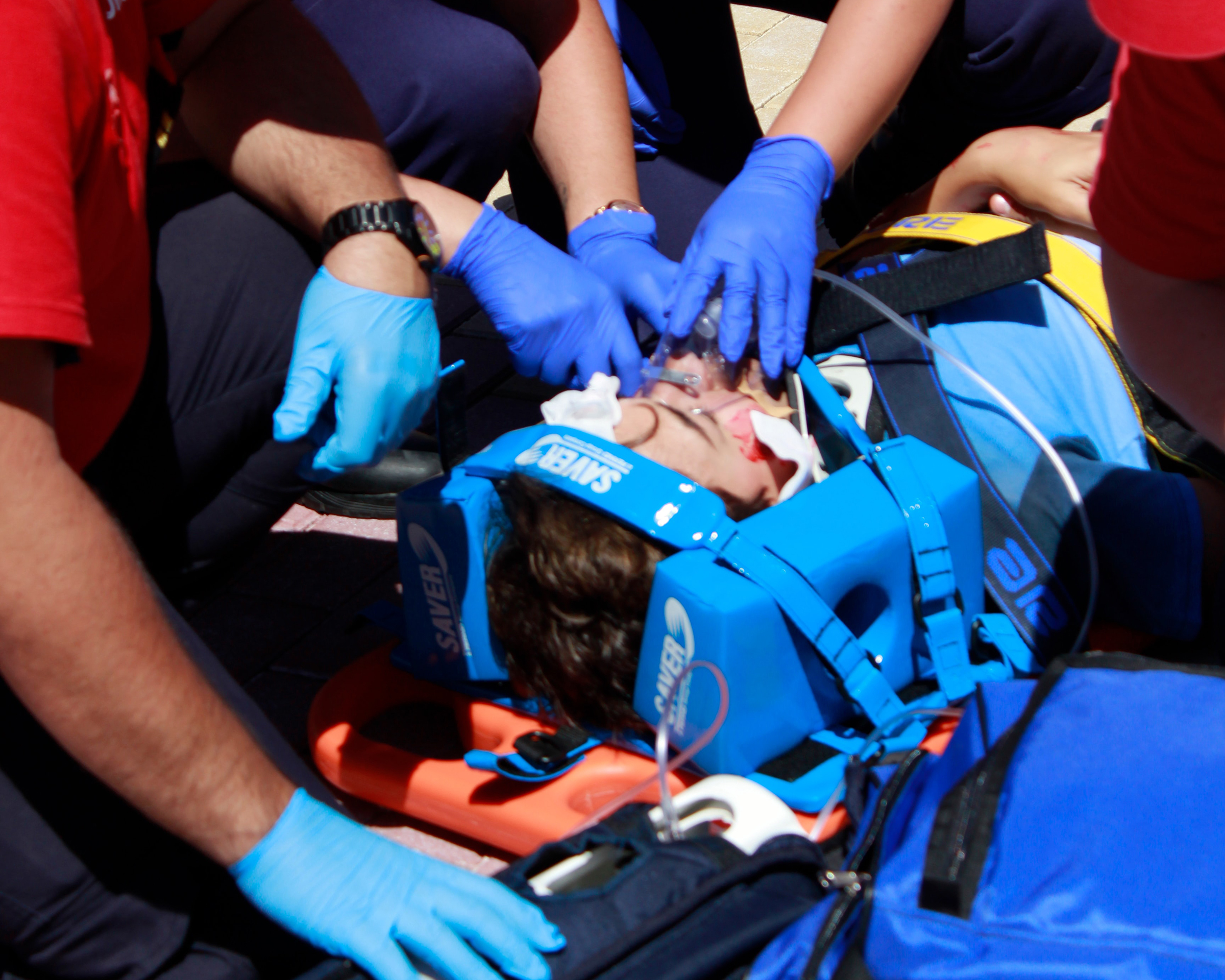 Person strapped to a board after an accident - Spinal Cord Injury